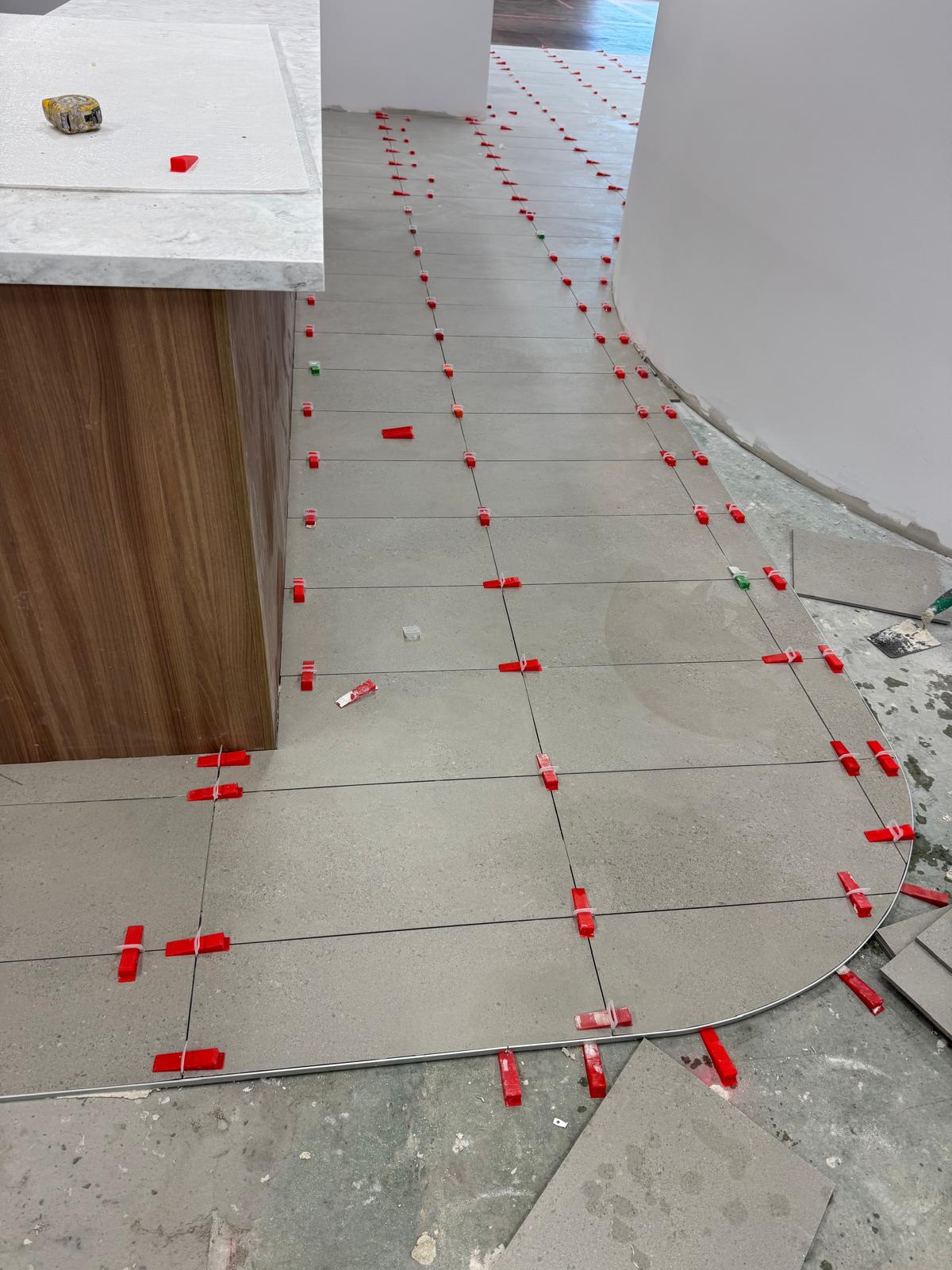 Large format tiled floor with a curved set out